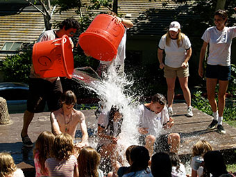 day campers dumping buckets of water on each other